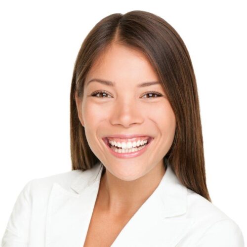 a smiling woman with long dark hair wearing a white coat