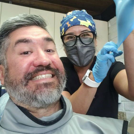 Dental worker getting ready to clean a patience's teeth.