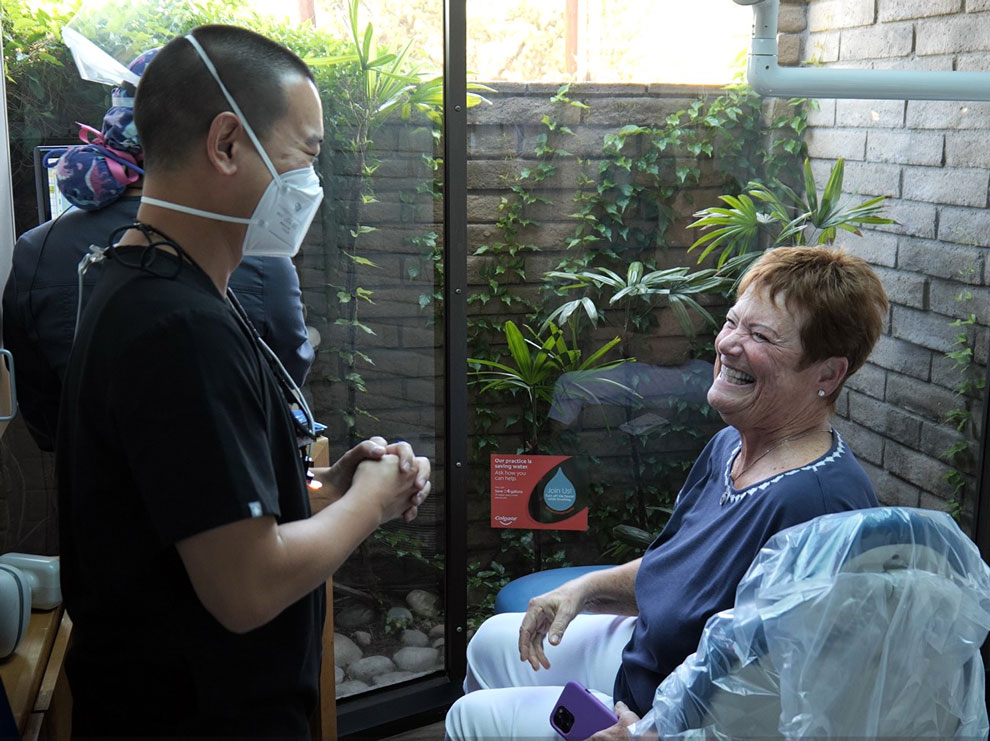 Lady with big smile as she talks with Dr. Kyle Low of Temple City Dental Care.