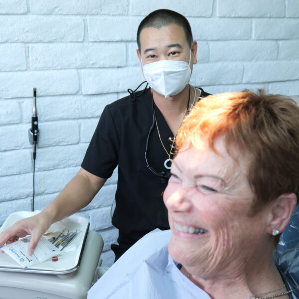 Dr. Kyle Low with patient in chair smiling.