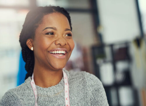 African-American lady with a big smile, showing off her newly Teeth Whitening For Life.
